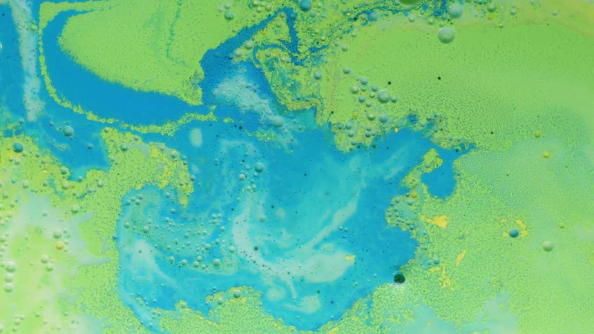 Blue green and white paint swirl together