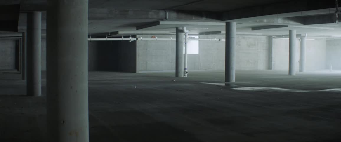 Concrete pillars stand in an empty room