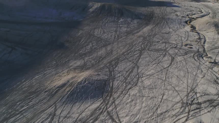 Dirt and hills cover a rural landscape