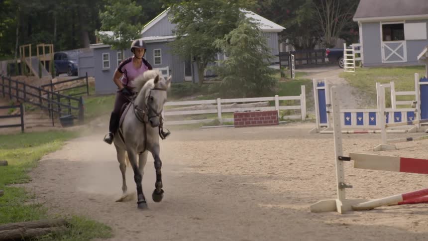 A young woman riding a horse