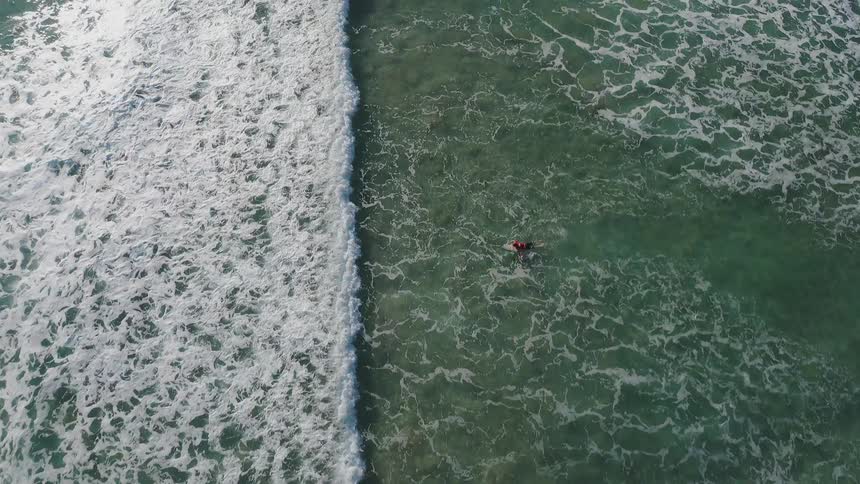 The ocean tide rolling in towards a small row boat