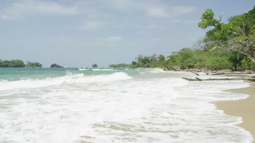 Ocean waves splash as they come to shore on a beach