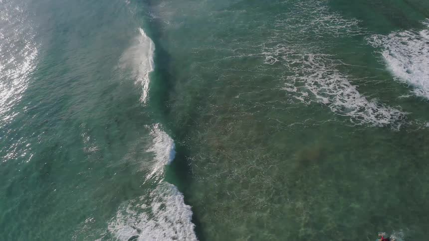 The waves move slowly crashing against the shore