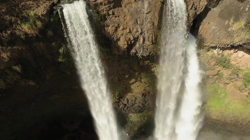Water cascading from a couple of high waterfalls in a forest area