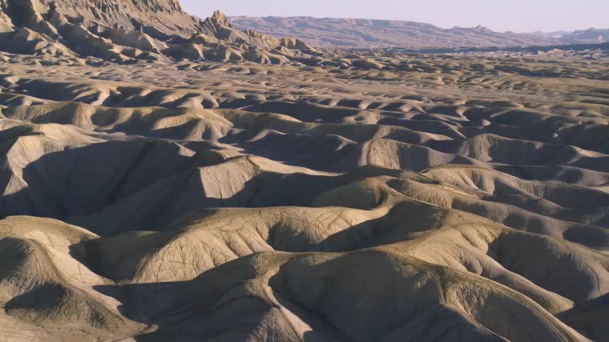 Dirt hills cover a rural landscape