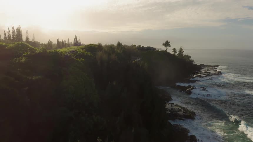 The sun sets over a shoreline