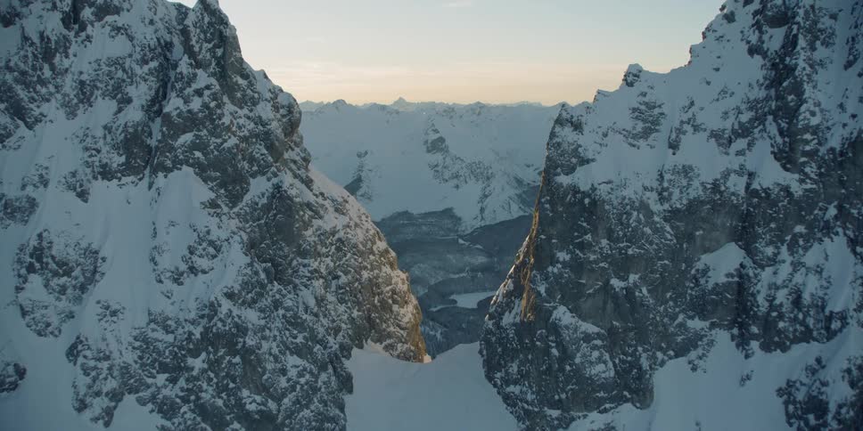Snow covered peaks and slopes at sunset