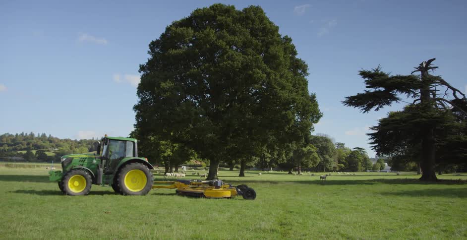 The farm vehicle is working the green field