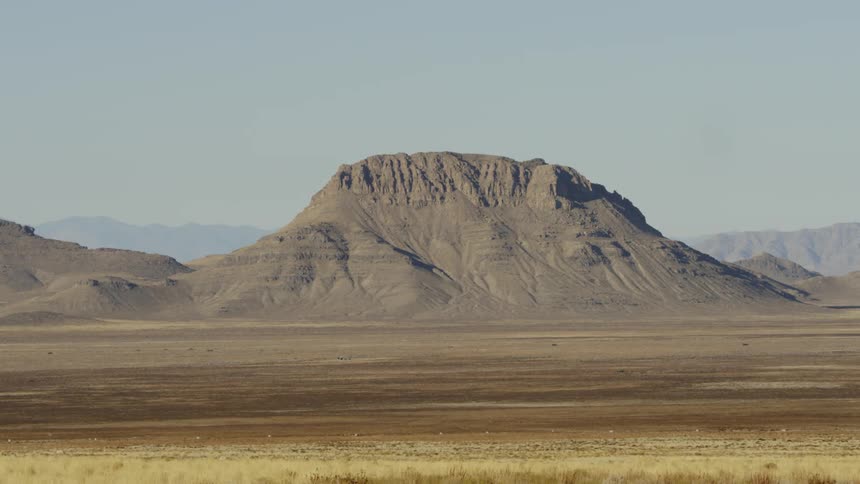 A mountain sits in the desert