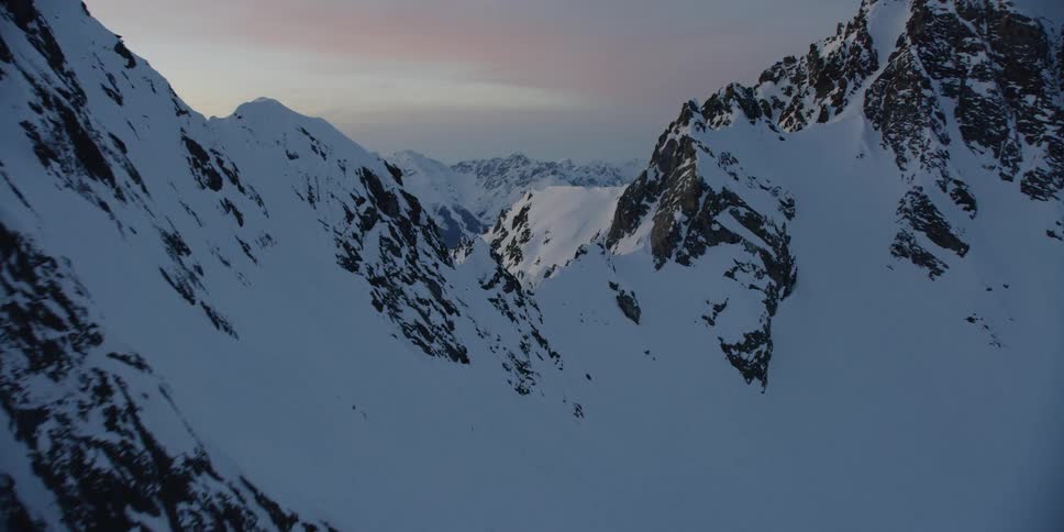 The tall mountains are touching the sky at sunset