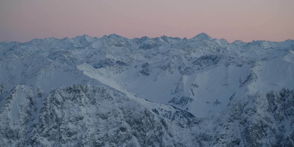 The mountain range is completely covered with snow