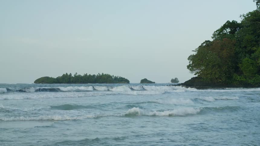 Waves flow onto the beach shore