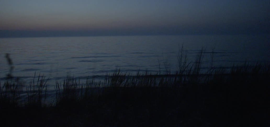Water flows on an ocean at dusk