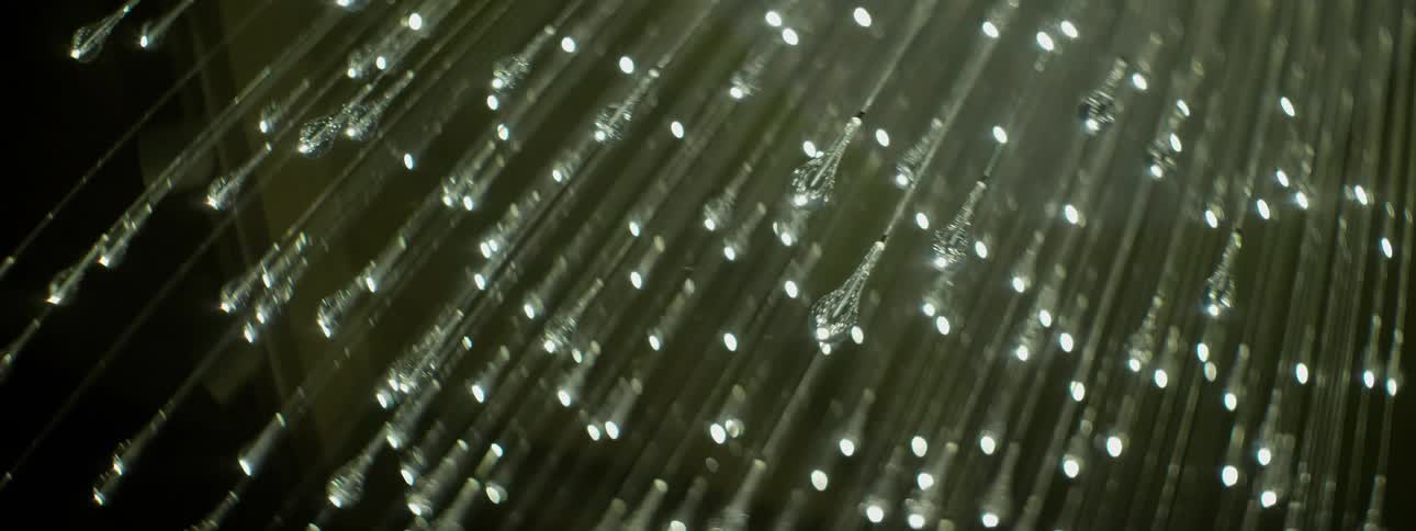 Small bulbs hang from long lines forming a light fixture
