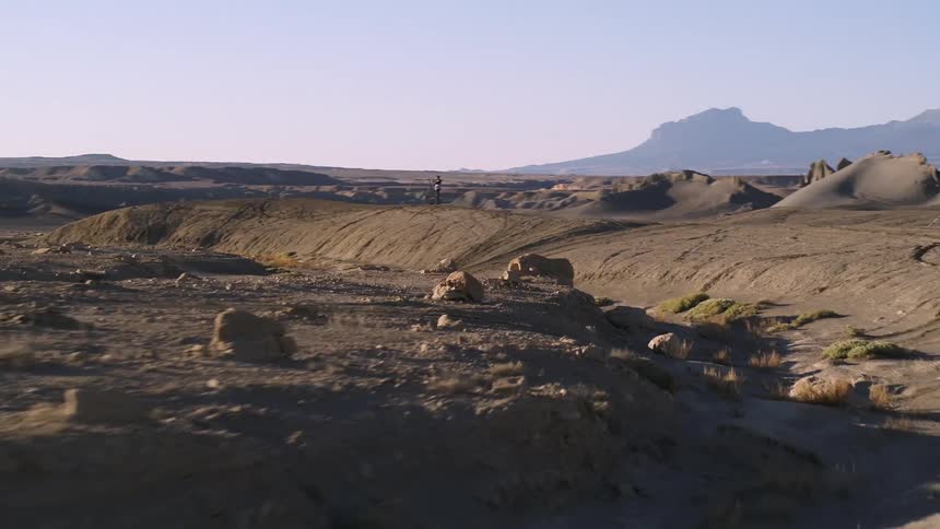 People have their trucks parked on the long range of hills