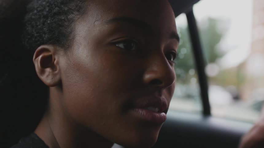 Woman sitting in a vehicle looking out the windows