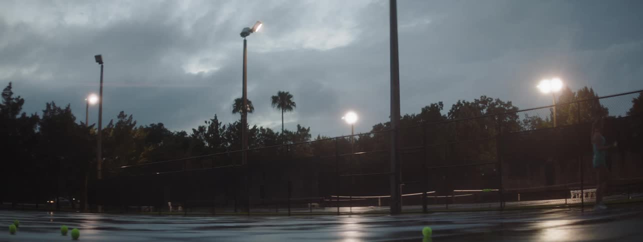 A woman plays tennis on an outdoor court