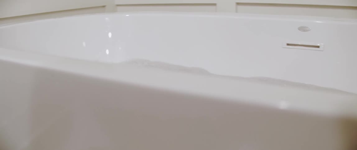 A child puts on goggles and jumps down in the tub