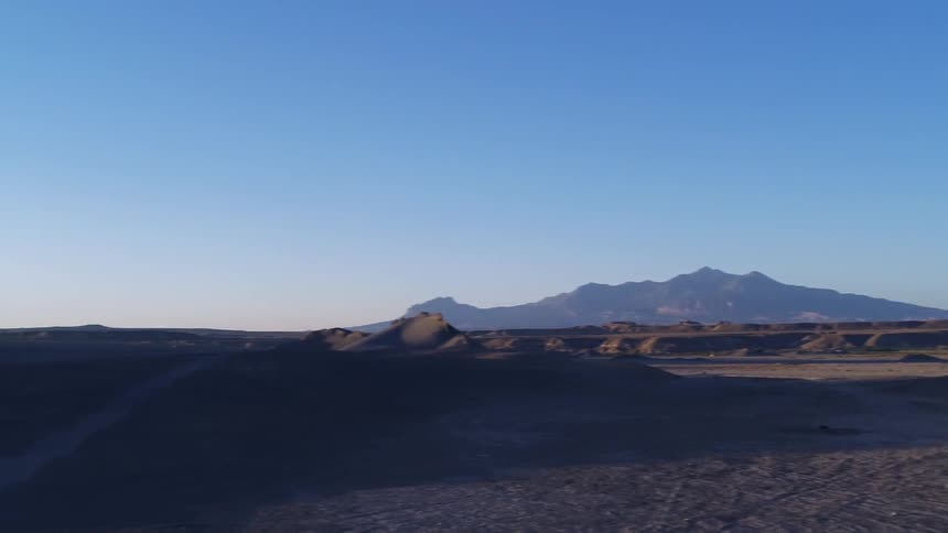 Plateaus in a sandy desert at sunset