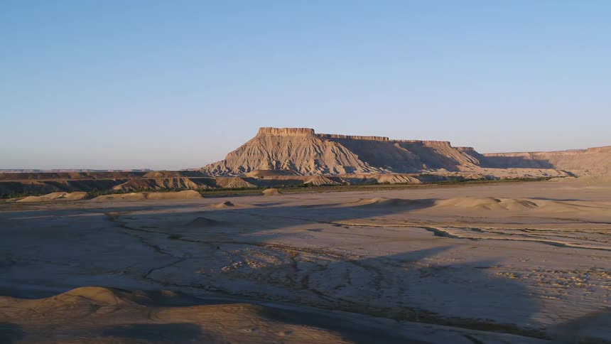A desert landscape is shown at sunset