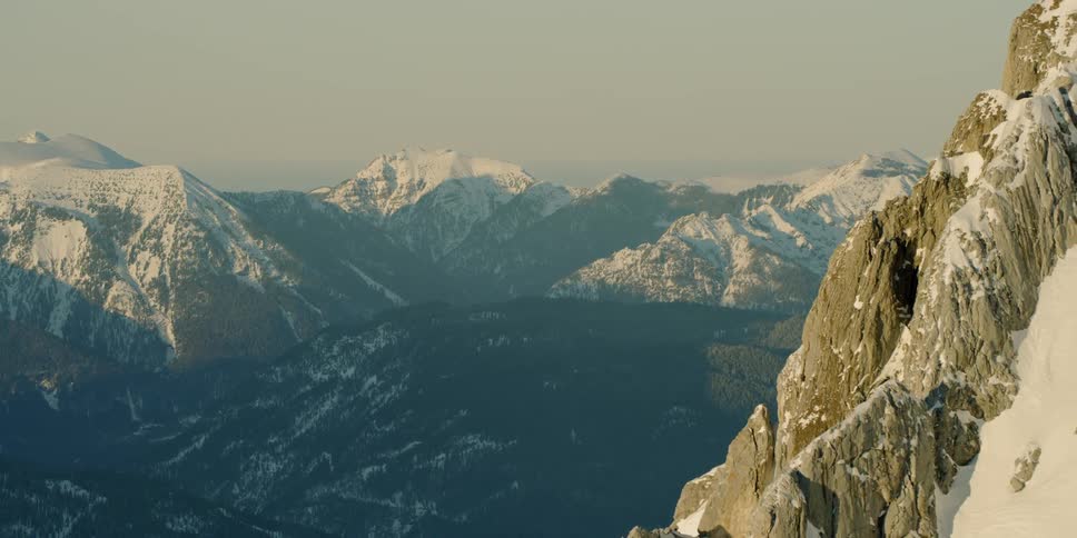 Snow and ice cover the tall mountains
