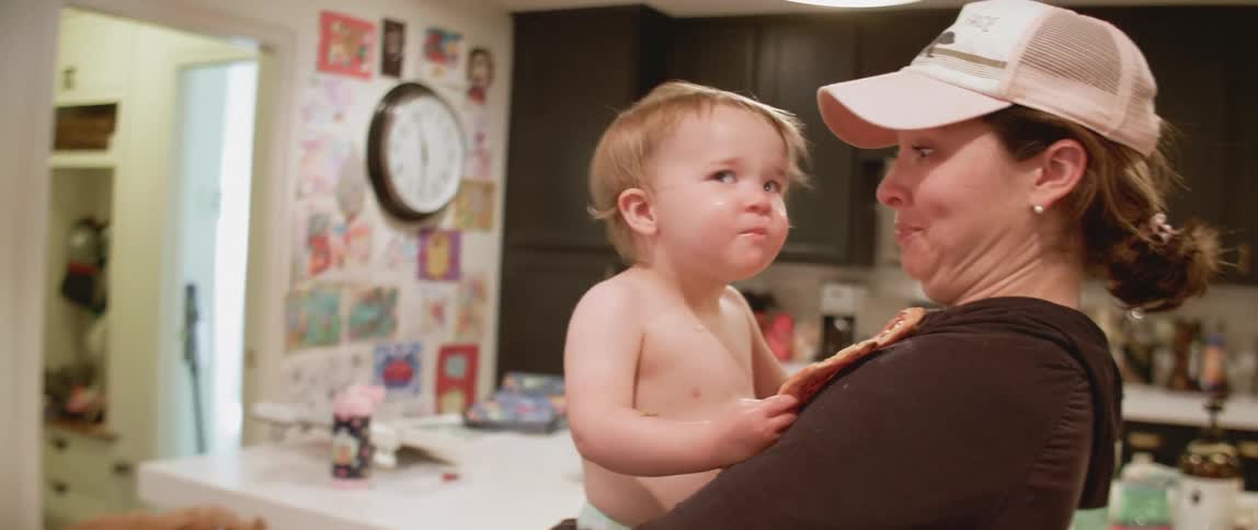 Woman holds and talks to a baby