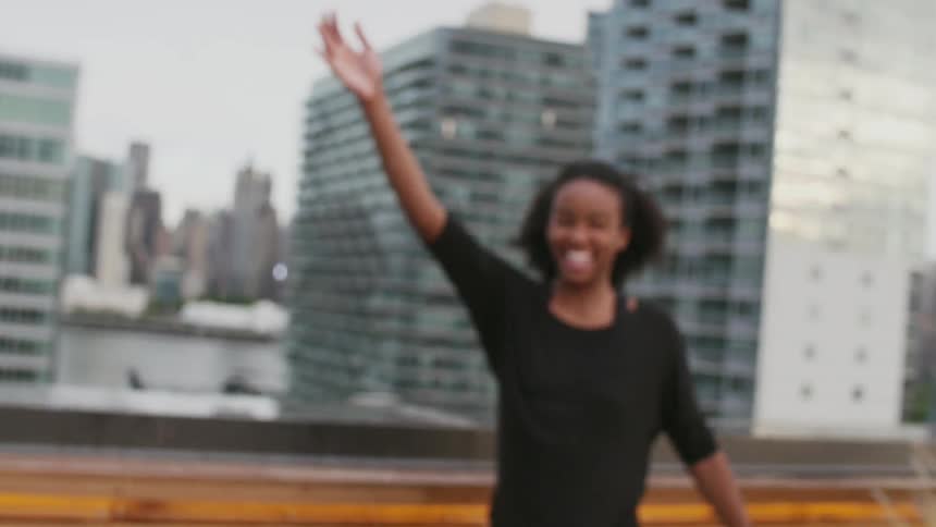Woman splashing water off a balcony