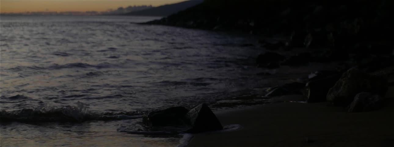 The tide flows onto the beach shore