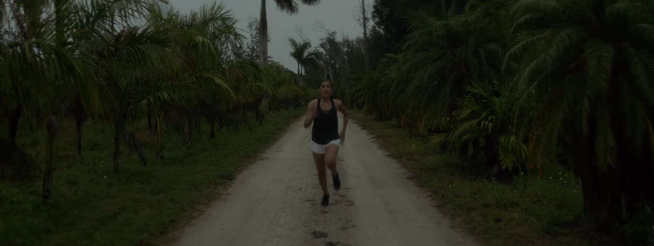 A woman jogs on a dirt road