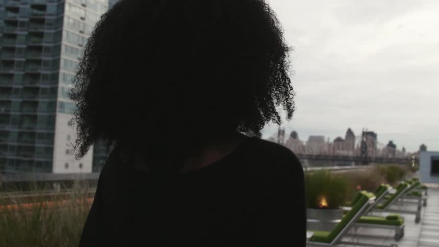 A woman standing on the roof of a building