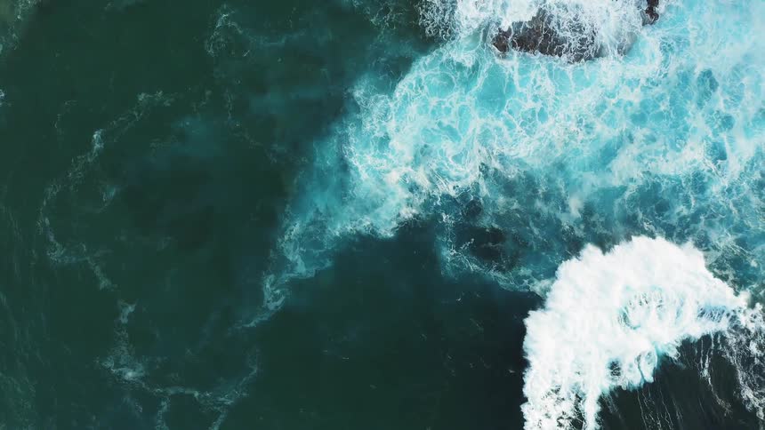 Water splashing in waves up on rocks