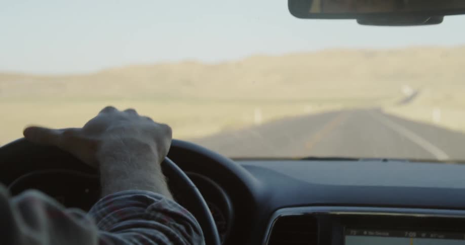 Person drives a vehicle through the country