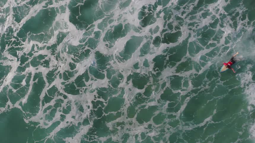 A person swims against the tide