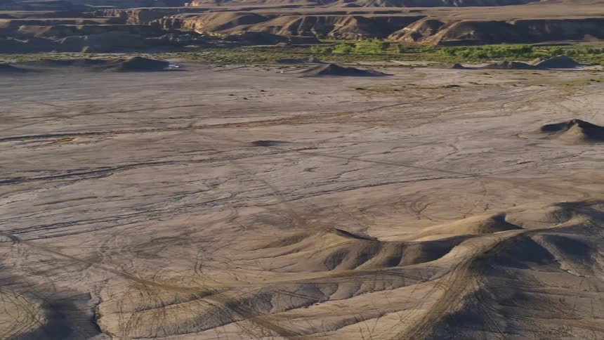 Hill formations cover the open landscape