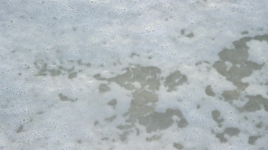 Ocean waves flow over sand