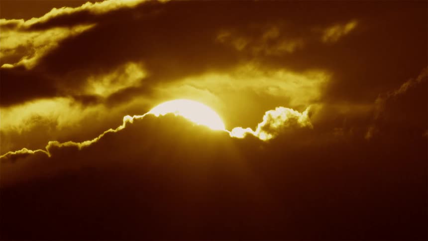 Clouds float in front of the sun