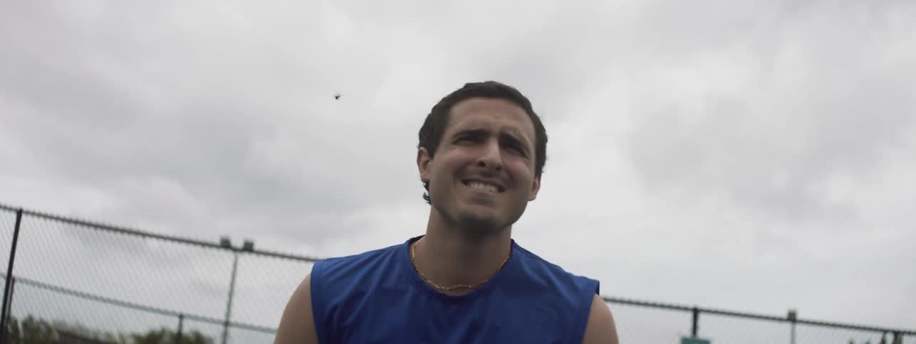 A man is playing tennis on the court