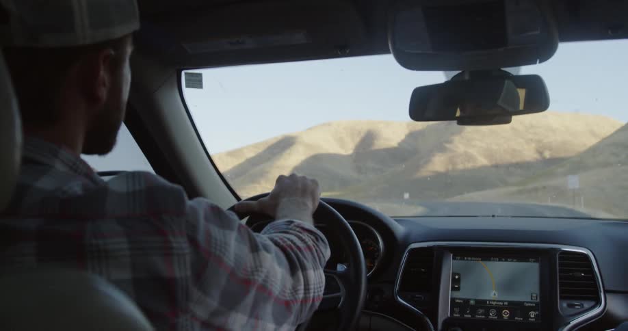 Man drives a car on a rural road