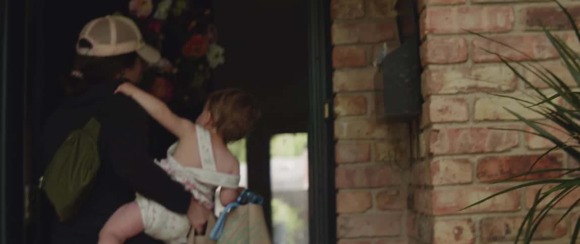 A woman carries a baby inside