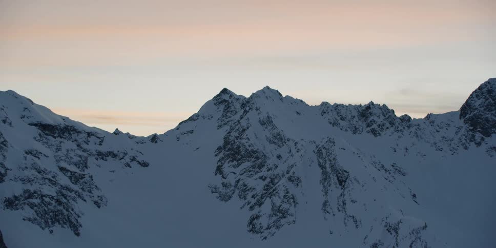 Snow covered peaks and ridges at sunset