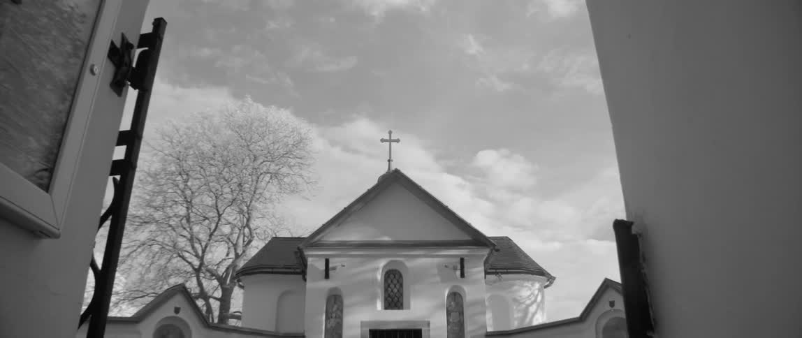 Sun shines over white church building