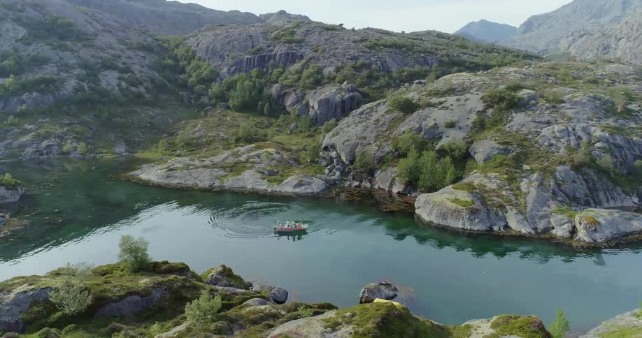 A boat in a mountain lake on a sunny day