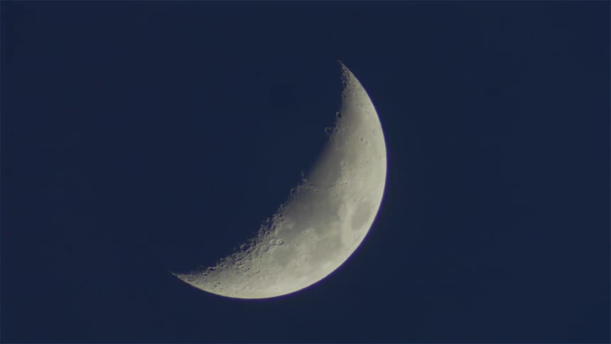 The moon glows in the night sky