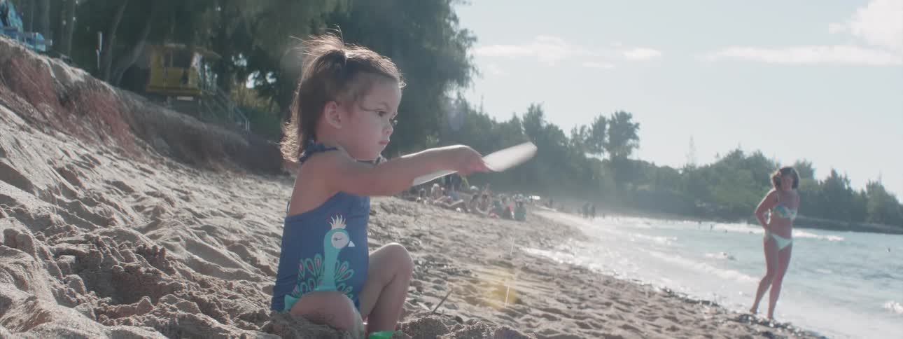 Young girl digs on a sandy beach