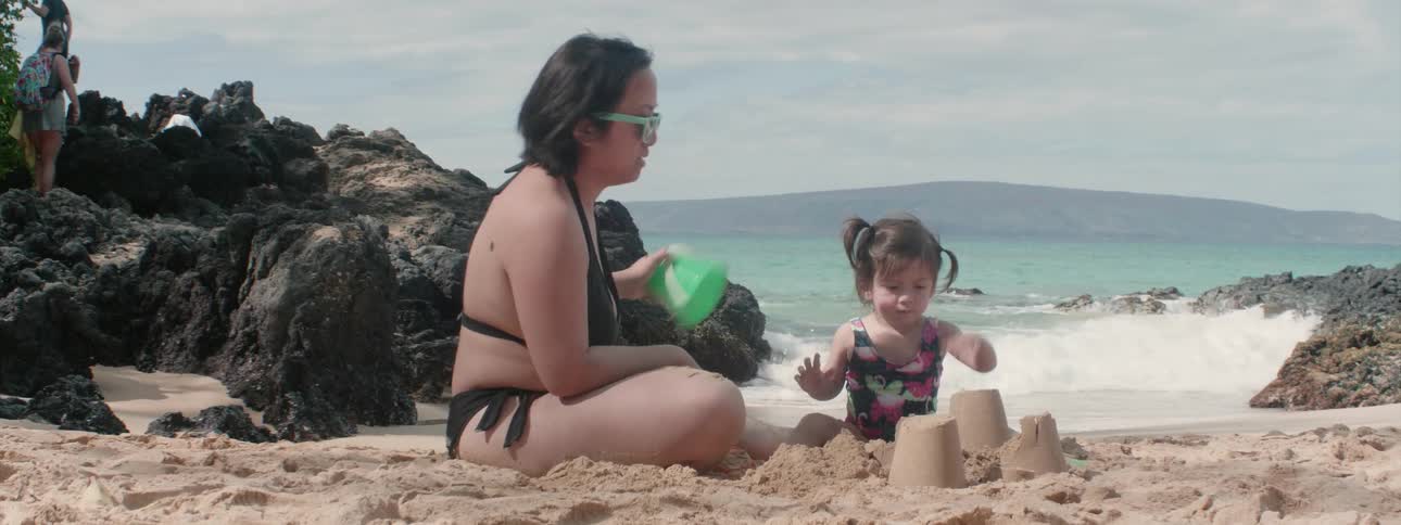 A woman smashes the child's sand castle