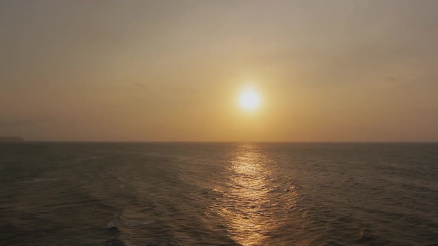 View of a large ocean as the sun sets