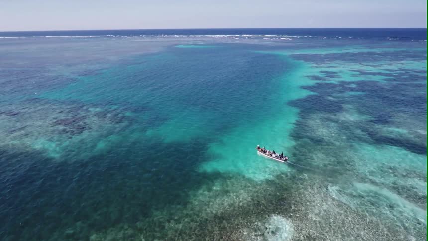 People are riding on a boat over the ocean