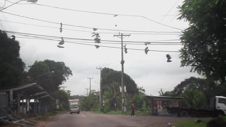 View of shoes hung over power lines on a city street