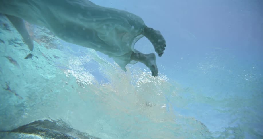 A woman in a white dress floating in water