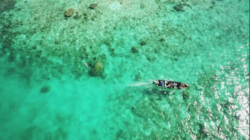 People are riding in a boat in the ocean water